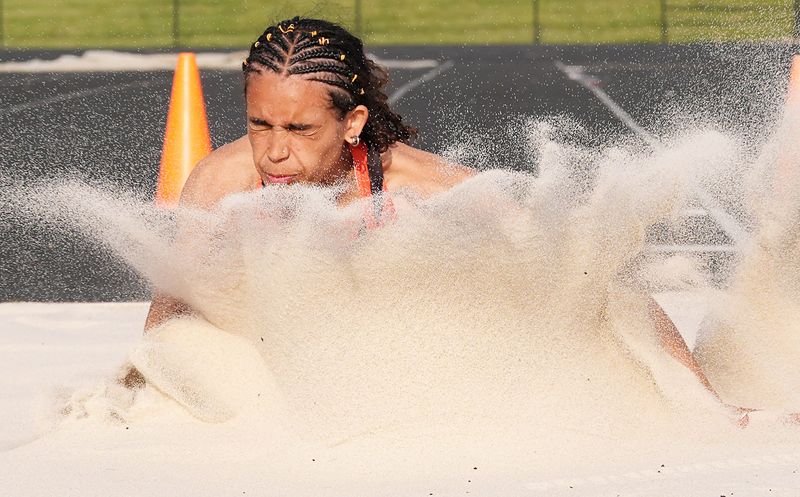 Ames girls long jumper Sophia Hatcher lands during one of her jumps at the Class 4A state qualifying co-ed track and field meet at the Indianola High School football field on May 14 in Indianola, Iowa. Hatcher and fellow seniors Angelica Attinger and Natalya Deardorff are all going on to compete in women's track and field next year in college, but they want one big sendoff next week at the 2026 Iowa high school boys and girls state track and field championships in Des Moines.