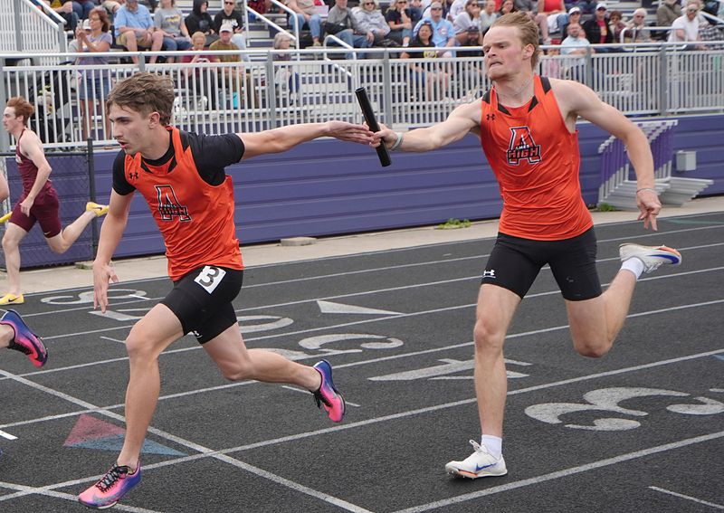 Ames senior Drew Vander Wilt (right), seen here handing the baton to Peyton Johnson in the boys sprint medley relay at the Class 4A state qualifying track and field meet in Indianola on May 14, qualified for the 2026 Iowa high school girls and boys state track and field championships in four events.