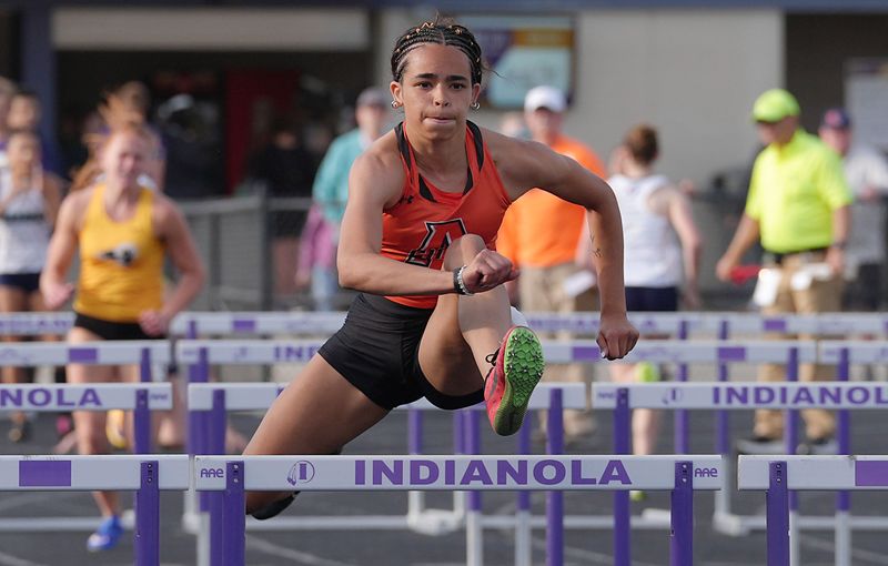 Ames’ anchor Sophia Hatcher crosses the hurdle during girls shuttle hurdles relay in the Iowa high school co-ed class 4A district meet at Indianola High School’s football field on May 14, 2026, in Indianola, Iowa.