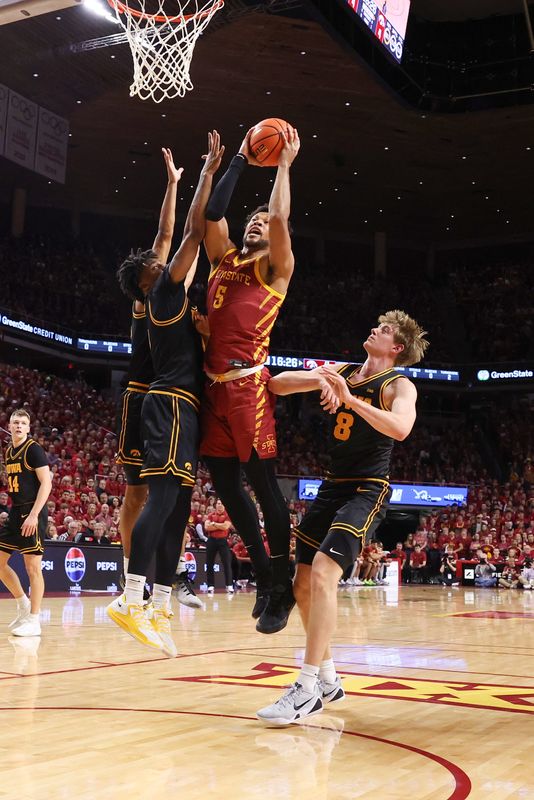 Dec 11, 2025; Ames; Iowa Hawkeyes guard Tavion Banks (6) defends Iowa State Cyclones forward Joshua Jefferson (5) during the first half at James H. Hilton Coliseum.