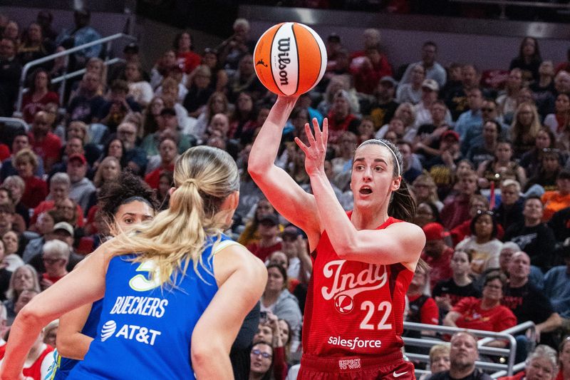 May 9, 2026; Indianapolis, Indiana, USA; Indiana Fever guard Caitlin Clark (22) passes the ball while Dallas Wings guard Paige Bueckers (5) defends in the first half at Gainbridge Fieldhouse. Mandatory Credit: Trevor Ruszkowski-Imagn Images
