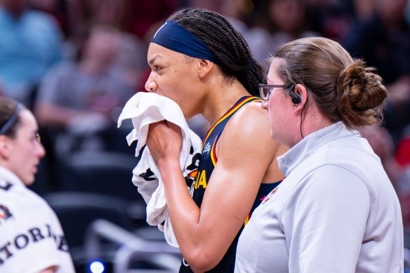 Indiana Fever forward-center Makayla Timpson (21) is walked off the court after an apparent injury during the second half of an WNBA basketball game against the Seattle Storm, Sunday, May 17, 2026, at Gainbridge Fieldhouse.