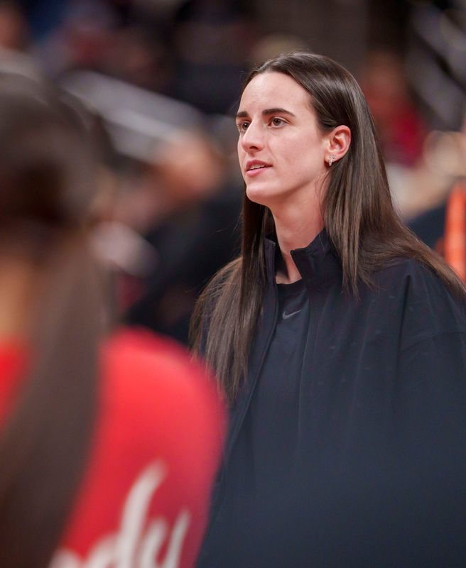 Indiana Fever guard Caitlin Clark (22) watches as her team mates warm up as the Portland Fire face the Indiana Fever Wednesday, May 20, 2026, at the Gainbridge Fieldhouse in Indianapolis.