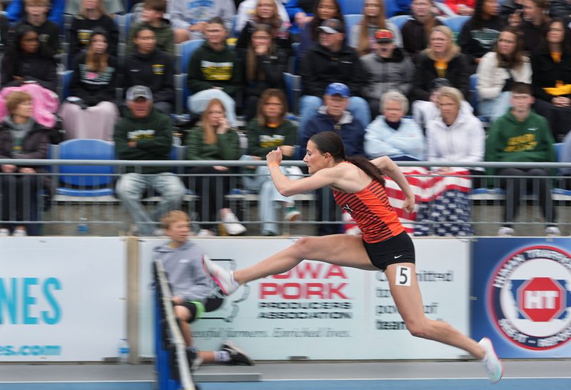 West Des Moines valley’s anchor runner Morgan Karr crosses the hurdle during 4A girls 4x100-meter shuttle hurdle relay in the Iowa state high school co-ed track and field at Drake Stadium on May 21, 2026, in Des Moines, Iowa.