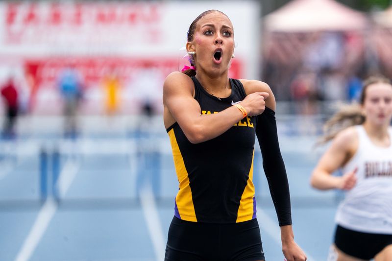 Waukee’s Jana Maharry looks to the scoreboard as she wins the girls 4A 400m hurdles during the Iowa high school state track meet on May 22, 2026, at Drake Stadium.