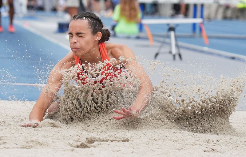 Ames’ Sophia Hatcher lands during the Class 4A girls long jump on day two of the Iowa high school girls and boys state track and field championships at Drake Stadium on May 22 in Des Moines, Iowa. Hatcher placed second with a school-record jump of 18 feet, 11.25 inches.