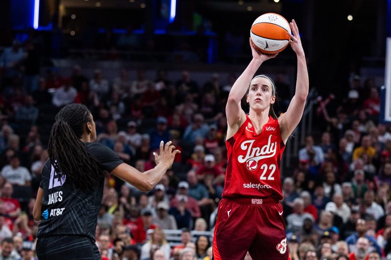 May 22, 2026; Indianapolis, Indiana, USA; Indiana Fever guard Caitlin Clark (22) shoots the ball while Golden State Valkyries guard Tiffany Hayes (15) defends in the second half at Gainbridge Fieldhouse. Mandatory Credit: Trevor Ruszkowski-Imagn Images
