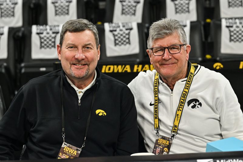 Jan 3, 2026; Iowa City, Iowa, USA; Iowa Hawkeye radio announcers Bobby Hansen (left) and Gary Dolphin (right) look on before the game between the Iowa Hawkeyes and the UCLA Bruins at Carver-Hawkeye Arena. Mandatory Credit: Jeffrey Becker-Imagn Images