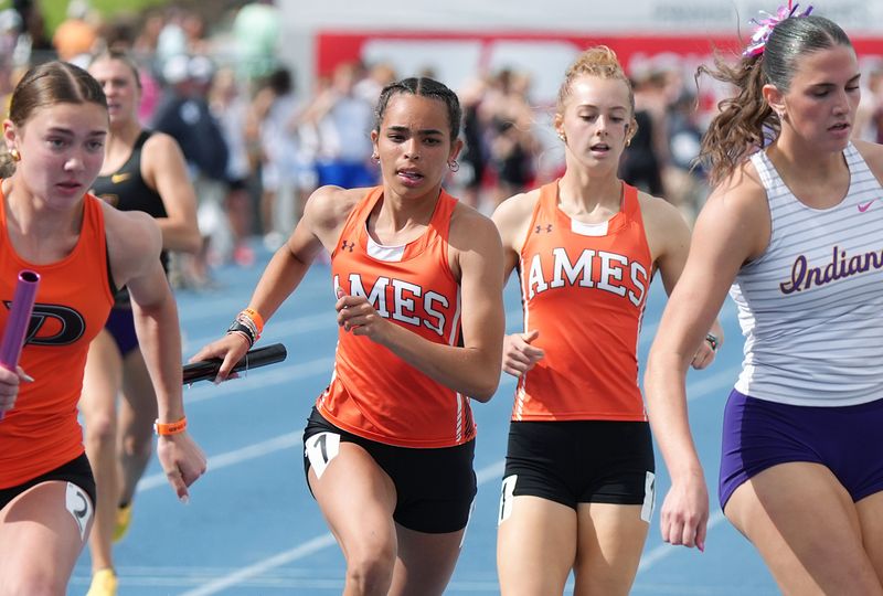 Ames seniors Sophia Hatcher and Brenna Van Cleave exchange the baton during the Class 4A girls 4x400-meter relay on the final day of the Iowa high school girls and boys state track and field championships at Drake Stadium on May 23 in Des Moines, Iowa.