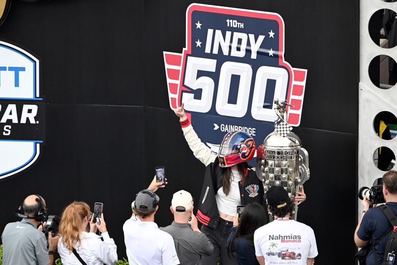 May 24, 2026; Indianapolis, Indiana, USA; Indiana Fever guard Caitlin Clark poses with the Borg-Warner trophy before the 110th Running of the Indianapolis 500 at Indianapolis Motor Speedway. Mandatory Credit: Marc Lebryk-Imagn Images
