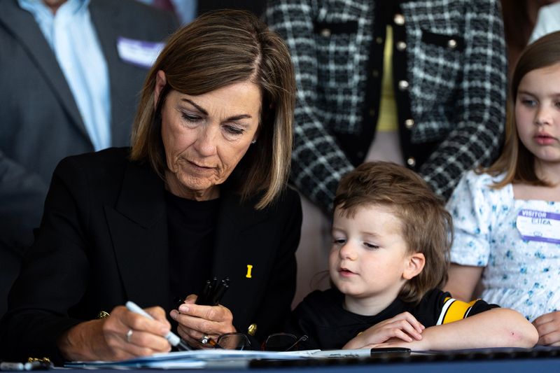 Gov. Kim Reynolds signs a bill to allocate millions for pediatric cancer research via a vape tax May 26, 2026 at the Stead Family Children’s Hospital in Iowa City, Iowa.