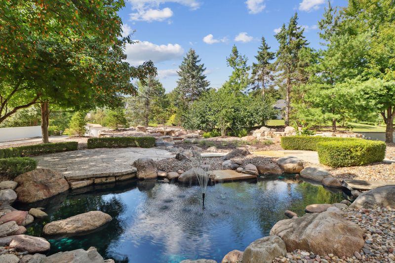 Water feature outside home for sale at 3700 Hidden Creek Drive, West Des Moines.