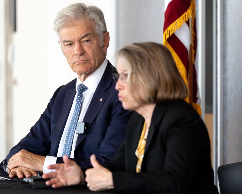 Centers for Medicare & Medicaid Services Administrator Dr. Mehmet Oz listens as Rep. Mariannette Miller-Meeks speaks during a press conference May 27, 2026 at the Stead Family Children’s Hospital in Iowa City, Iowa.