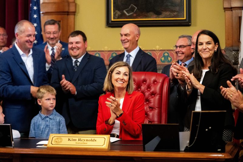 Iowa Gov. Kim Reynolds signs the state’s agriculture budget, HF 2771, and the Iowa Farm Bill, SF 2465, into law during a bill signing ceremony on June 1, 2026, at the Iowa State Capitol.