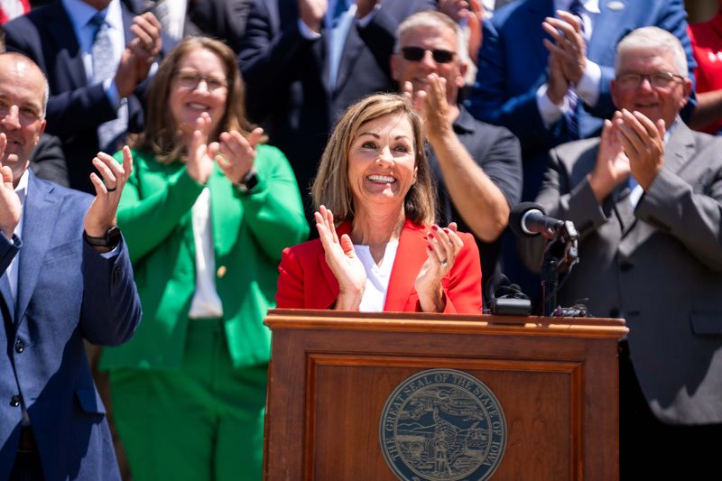 Gov. Kim Reynolds signs SF 2493, a bill that exempts E85 from sales tax, on June 1, 2026, in Des Moines.