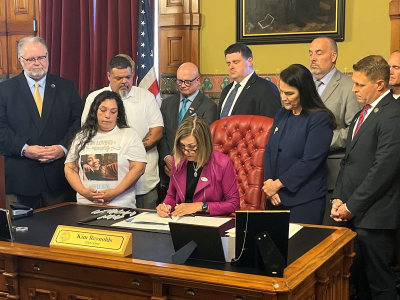 Gov. Kim Reynolds signs House File 2542, a "three strikes" law with a seven-year mandatory minimum prison sentence for someone convicted of a third felony, at the Iowa Capitol, on Tuesday, June 2, 2026.