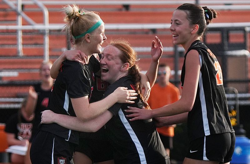 Ames forward Kate Badding (13) celebrates with teammates after a scoring a goal against Sioux City East during the first half of the Little Cyclones' 4-0 victory over the Black Raiders in the Class 3A girls Region 4 semifinal at the Ames High Football Stadium on June 2 in Ames, Iowa.