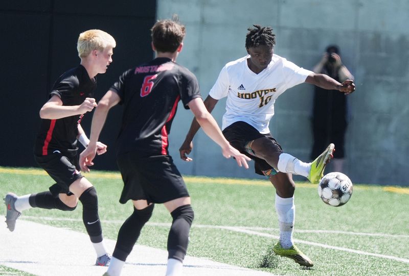 Des Moines Hoover midfielder Isack Ramadhani (10) clears the ball against Dallas Center-Grimes during the first half in the 3A boys State semi-final at Mediacom Stadium on June 3, 2026, in Des Moines, Iowa