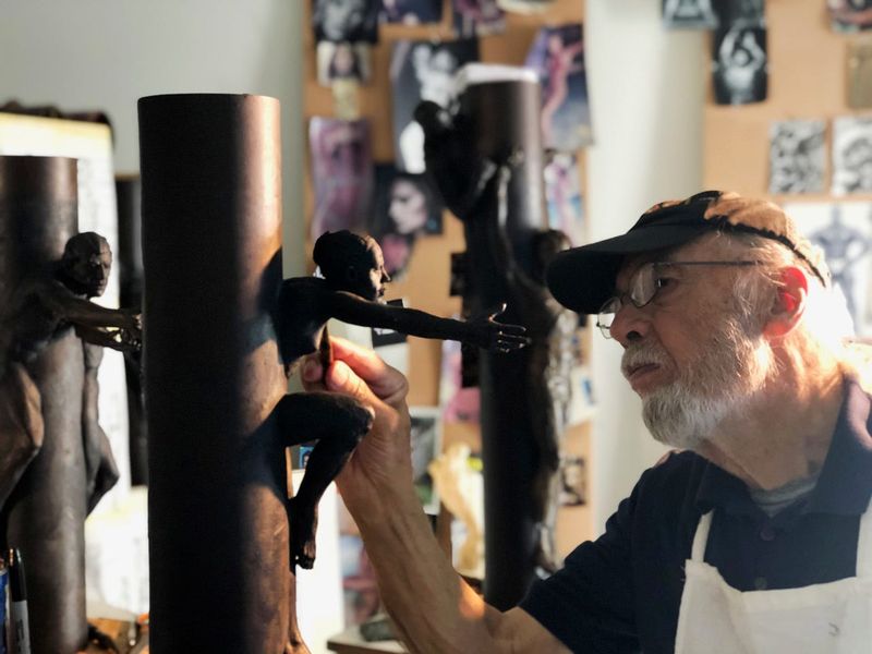 Tom Schomberg works in his studio on figures for his 9/11 series of sculptures.