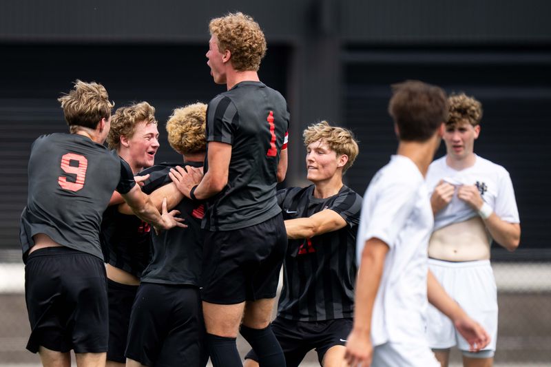 Gilbert celebrates a goal scored by Drew Chapman (7) aduring the 2A state semifinal game against Bishop Heelan on June 4, 2026, at Mediacom Stadium in Des Moines.