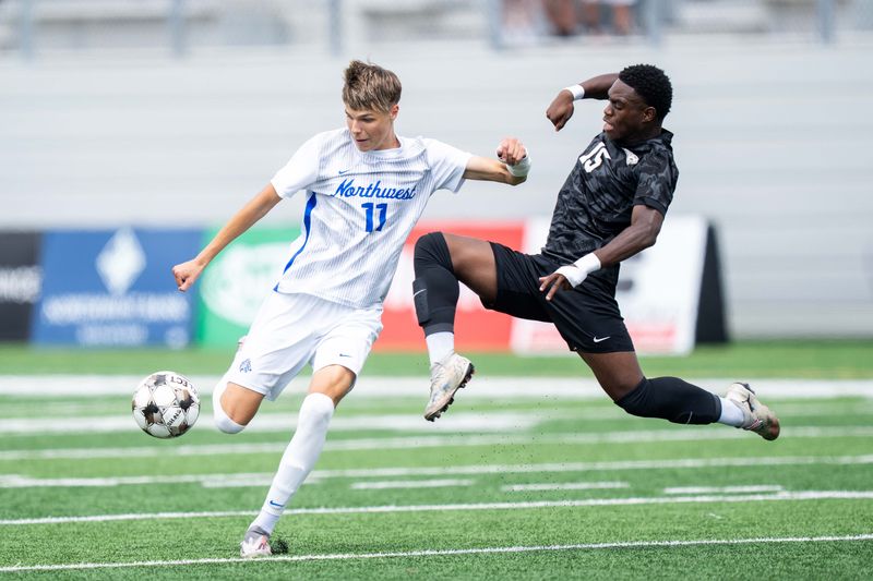 Waukee Northwest's Eman Alicic (11) looks to shoot as Ankeny Centennial's Marcus Gabriel (15) challenges the ball on June 5, 2026, at Mediacom Stadium in Des Moines.