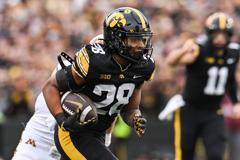 Oct 25, 2025; Iowa City, Iowa, USA; Iowa Hawkeyes running back Kamari Moulton (28) runs the ball against the Minnesota Golden Gophers during the first quarter at Kinnick Stadium. Mandatory Credit: Jeffrey Becker-Imagn Images