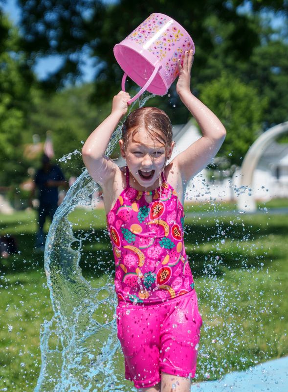 Macie Horn, 8, plays in the splash pad in Columbus Park, Tuesday, June 9, 2026, in Des Moines.