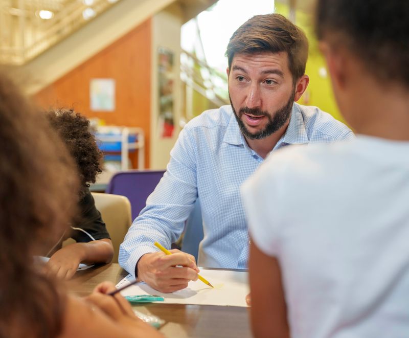 Tanner Krause spends time coloring and talking with children at the Levitt Boys & Girls Club at Carver Elementary in Des Moines. Krause is taking on the interim CEO role of Boys & Girls Clubs of Central Iowa until the position can be filled permanently.