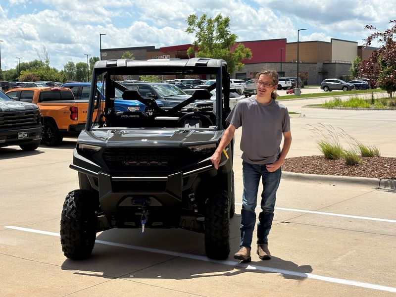 Zander Smith stands with a Polaris RANGER 1000 June 17, 2026, outside Warner's Stellian Appliances in West Des Moines after having his Make-A-Wish request granted.