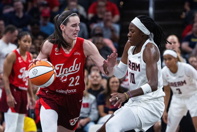 Jun 18, 2026; Indianapolis, Indiana, USA; Indiana Fever guard Caitlin Clark (22) dribbles against Atlanta Dream guard Rhyne Howard (10) in the first half at Gainbridge Fieldhouse. Mandatory Credit: Trevor Ruszkowski-Imagn Images