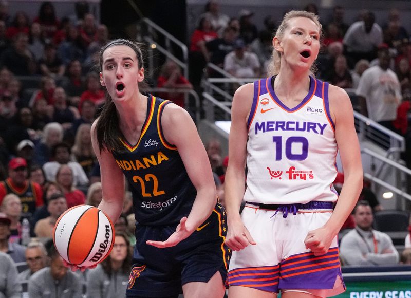 Indiana Fever guard Caitlin Clark (22) reacts to a foul called as Phoenix Mercury forward Ashten Prechtel (10) yells in excitement on Monday, June 22, 2026, during the game at Gainbridge Fieldhouse in Indianapolis.