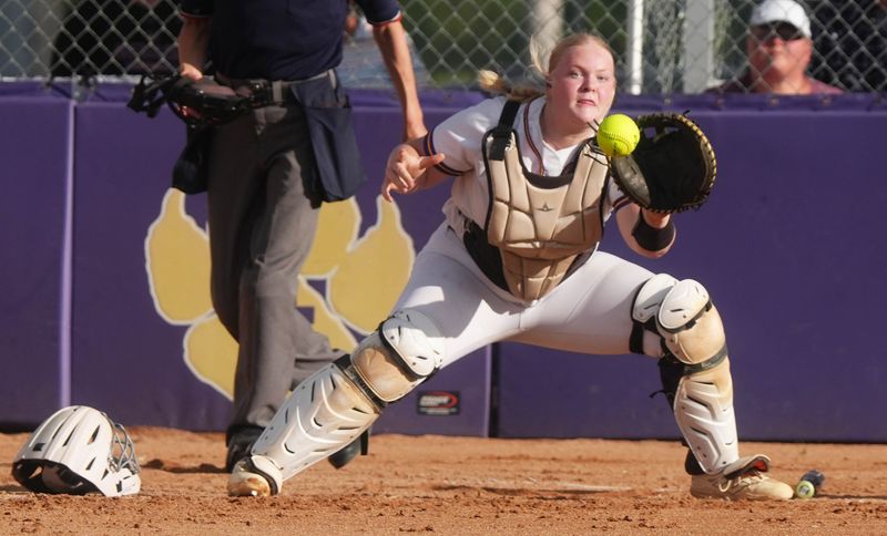 Nevada catcher Olivia Clausen (15) catches a throw home during the team's 6-4 victory over South Tama County on June 23 in Nevada. Clausen is a talented and reliable presence behind the plate and a vocal leader for an improving Cub program.
