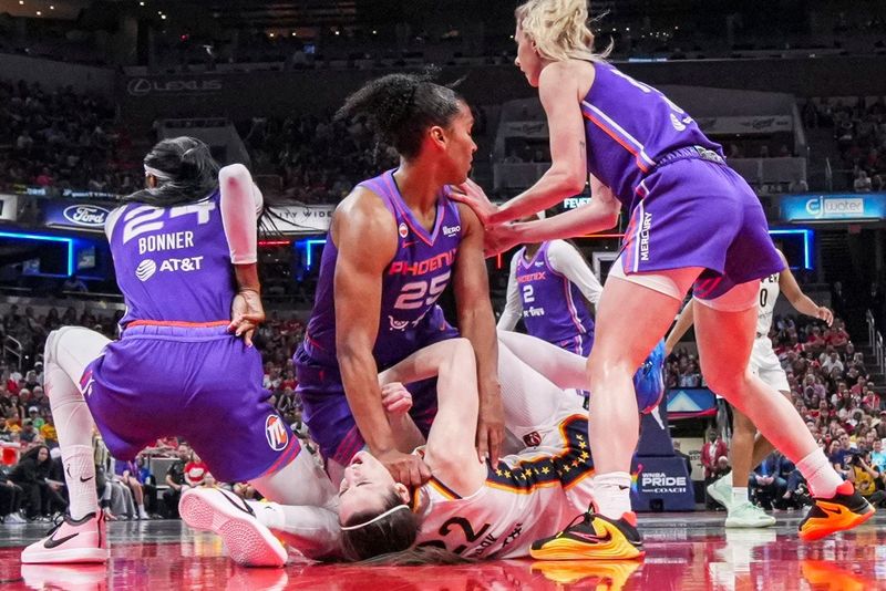 Phoenix Mercury forward Alyssa Thomas (25) scrambles to get up over Indiana Fever guard Caitlin Clark (22) on Wednesday, June 24, 2026, during a game at Gainbridge Fieldhouse in Indianapolis.