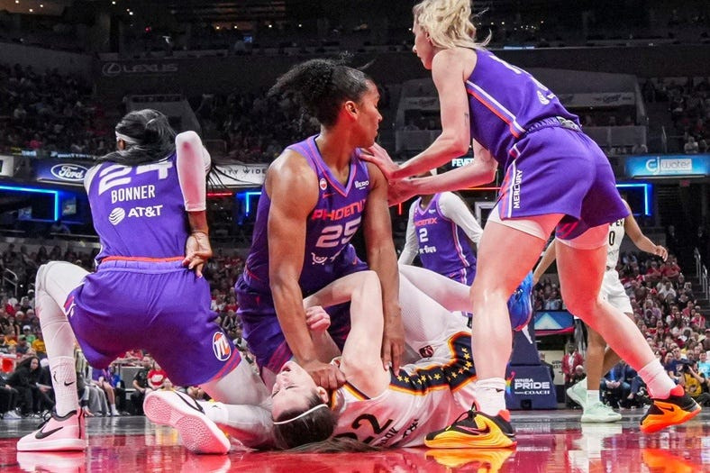 Phoenix Mercury forward Alyssa Thomas (25) scrambles to get up over Indiana Fever guard Caitlin Clark (22) on Wednesday, June 24, 2026, during a game at Gainbridge Fieldhouse in Indianapolis. The Phoenix Mercury defeated the Indiana Fever, 111-109.