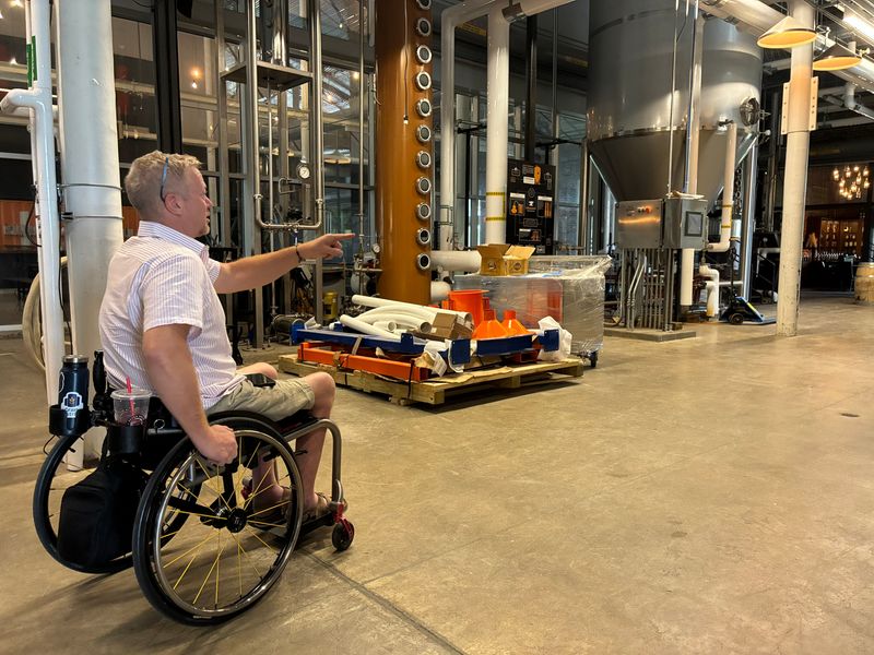 Scott Turczynski, founder of T12 Distillery, points June 26, 2026, to features of the space T12 acquired at The Foundry building in West Des Moines, at 111 S. 11th St. The space had been home to Foundry Distilling Co., which T12 bought the assets of.