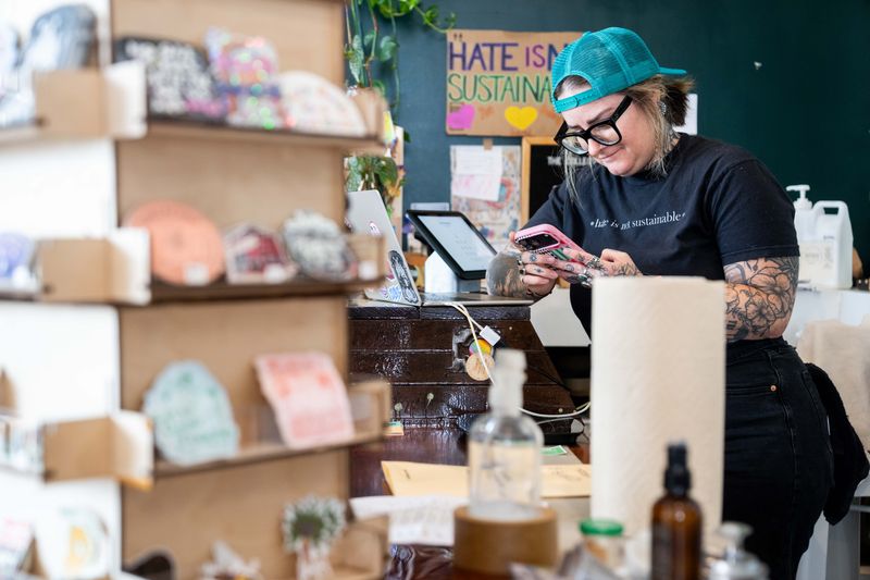 Jamie Nicolino, owner of The Collective, works at her store on June 26, 2026, in Des Moines. Nicolino, who is Nicole Nayima's sister, has also raised concerns about a sudden rise in costs for business owners who share retail space in the Highland Park Neighborhood.