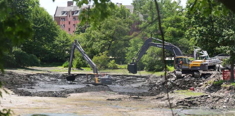 Construction workers clean up the mud renovate Lake LaVerne on June 26, 2026, in Ames, Iowa