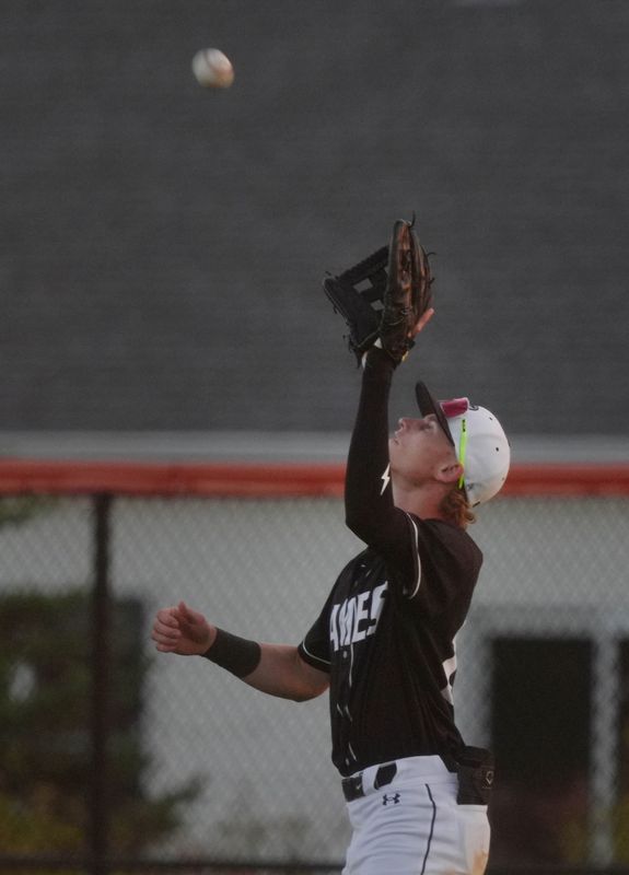 Ames center fielder Cullen Smith (27) catches a fly ball for a out against Dowling Catholic during the third inning at the Ames High Baseball Field on June 26 in Ames, Iowa.