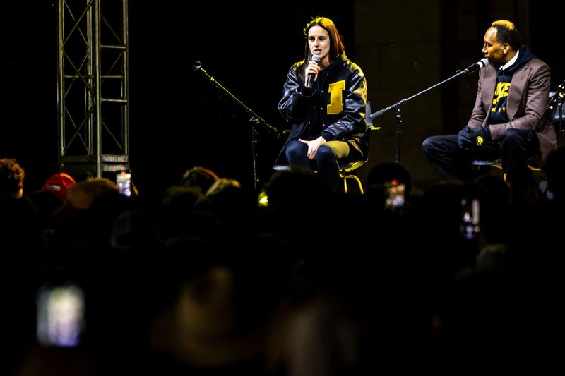 Caitlin Clark, left, speaks while on a panel with Stephen A. Smith after the University of Iowa Homecoming parade, Friday, Oct. 6, 2023, in Iowa City, Iowa.