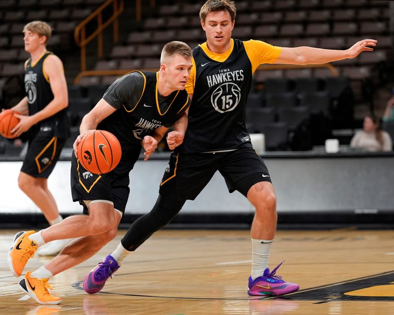 Iowaâ€™s Brendan Hausen (15) guards Bennett Stirtz (14) during a drill at practice Oct. 15, 2025 at Carver-Hawkeye Arena in Iowa City, Iowa.