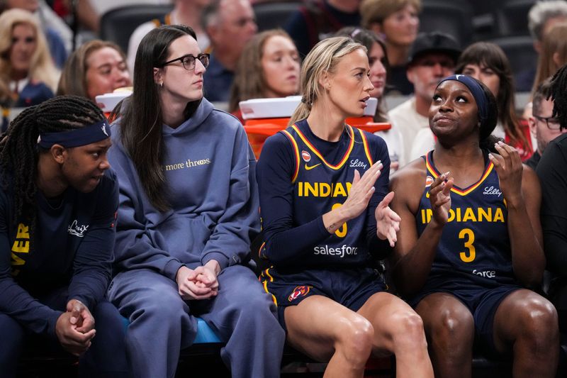 Indiana Fever forward Myisha Hines-Allen (2), Indiana Fever guard Caitlin Clark (22), Indiana Fever guard Sophie Cunningham (8) and Indiana Fever guard Raven Johnson (3) sit on the bench Saturday, June 27, 2026, during the first half of a game at Gainbridge Fieldhouse in Indianapolis.