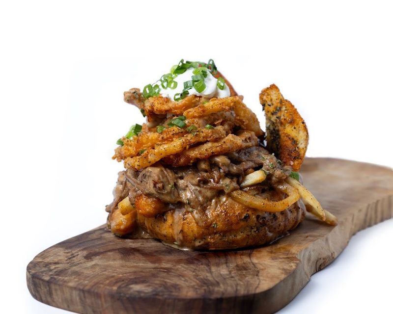 Blue Ribbon Bar & Eatery introduces the 1776 Liberty Bowl with a sourdough bread bowl loaded with crispy cheese curds, French fries and slow-roasted shredded beef, all smothered in gravy and topped with hand-breaded onion rings at the 2026 Iowa State Fair.
