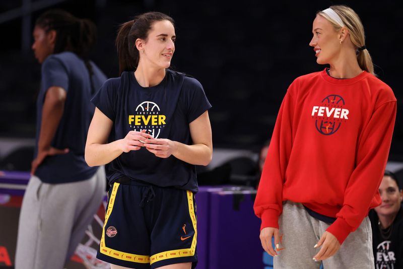 Jul 8, 2026; Los Angeles, California, USA; Indiana Fever guard Caitlin Clark (left) talks with guard Lexie Hull (right) during warmups before the game against the Los Angeles Sparks at Crypto.com Arena. Mandatory Credit: Kiyoshi Mio-Imagn Images