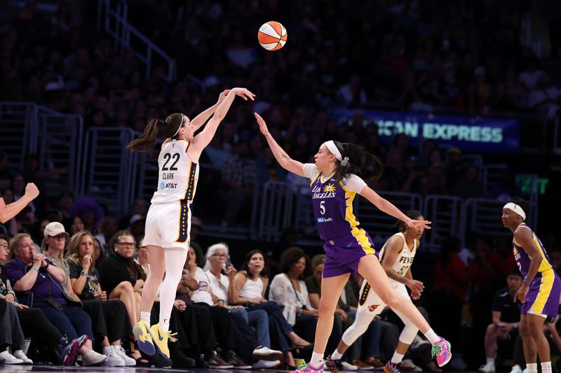 Jul 8, 2026; Los Angeles, California, USA;  Indiana Fever guard Caitlin Clark (22) shoots the ball over Los Angeles Sparks forward Dearica Hamby (5) during the fourth quarter at Crypto.com Arena. Mandatory Credit: Kiyoshi Mio-Imagn Images