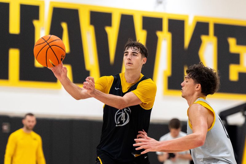 Iowa guard Tate Sage passes the basketball as Isaia Howard defends during an Iowa men’s basketball practice July 15, 2026 at Carver-Hawkeye Arena in Iowa City, Iowa.