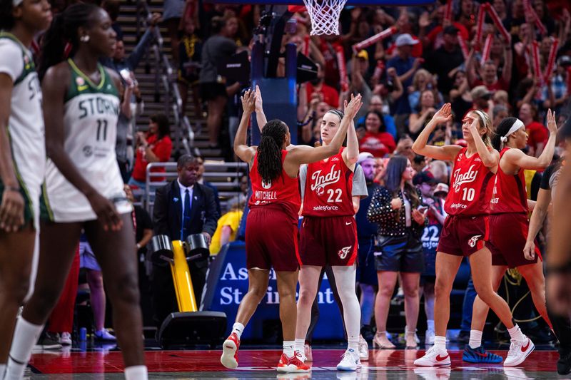 Jul 17, 2026; Indianapolis, Indiana, USA; Indiana Fever guard Caitlin Clark (22) celebrates with guard Kelsey Mitchell (0) after defeating the Seattle Storm in the second half at Gainbridge Fieldhouse. Mandatory Credit: Trevor Ruszkowski-Imagn Images