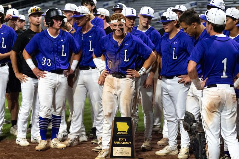 Iowa City Liberty baseball accepts their state participant trophy after losing to Sioux City East, 6-5, during the state baseball tournament quarterfinals on July 21.