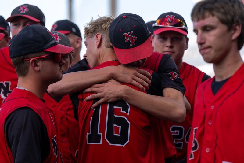 North Polk’s Jack Spieker (16) hugs a teammate after the Comets loss to the Wahlert Catholic Golden Eagles July 22, 2026 in a Class 3A Iowa state baseball tournament semifinal in Cedar Rapids, Iowa.