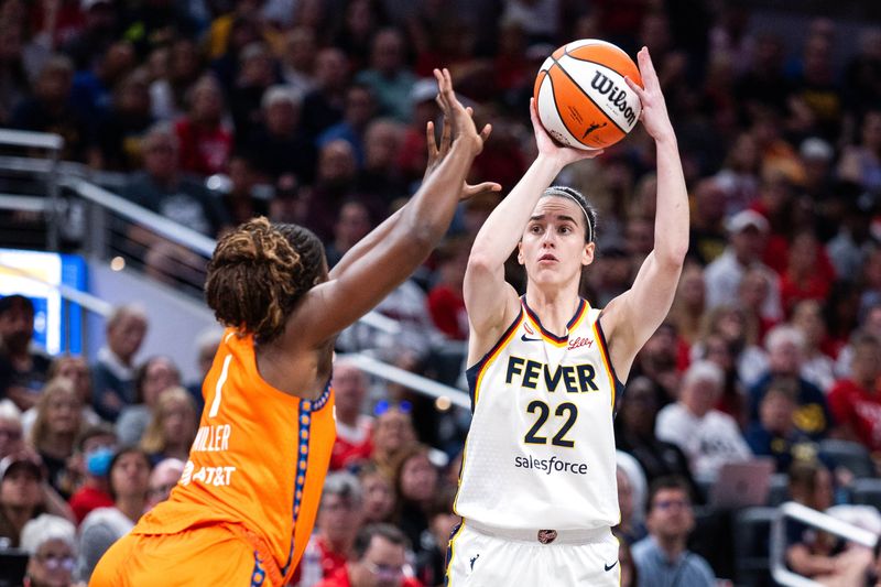 Jul 22, 2026; Indianapolis, Indiana, USA; Indiana Fever guard Caitlin Clark (22) shoots the ball while Connecticut Sun forward Diamond Miller (1) defends in the first half at Gainbridge Fieldhouse. Mandatory Credit: Trevor Ruszkowski-Imagn Images