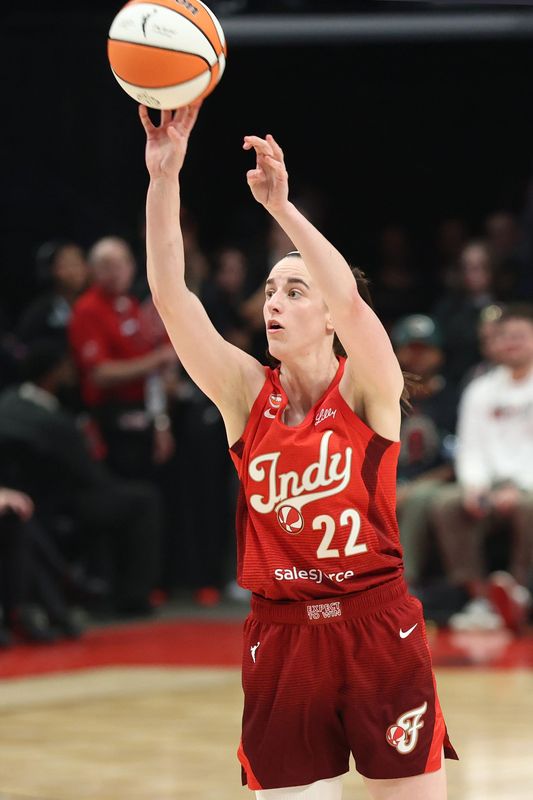 Jul 31, 2026; Portland, Oregon, USA;  Indiana Fever guard Caitlin Clark (22) shoots the ball against Portland Fire guard Holly Winterburn (77) during the first half at Moda Center. Mandatory Credit: Jaime Valdez-Imagn Images